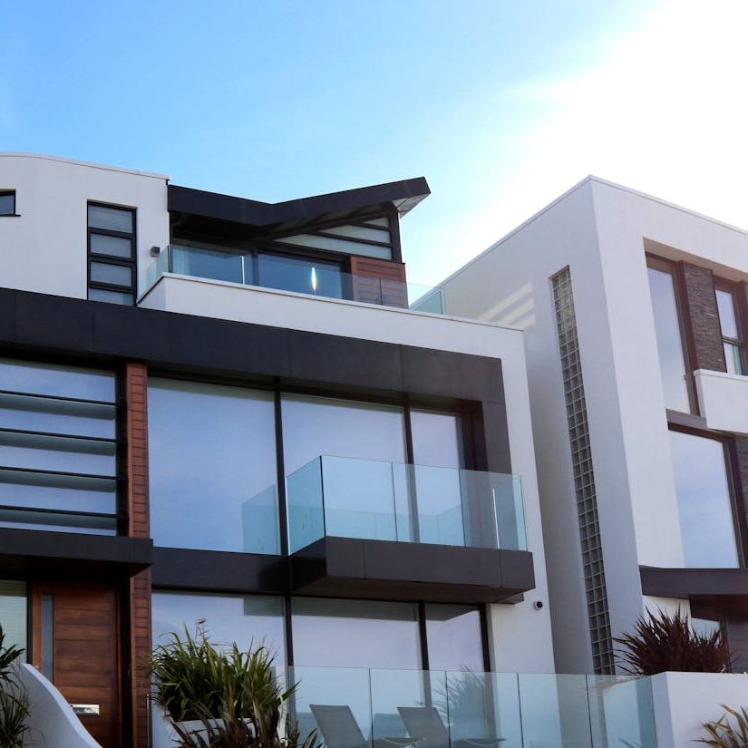 Contemporary luxury home with glass balconies in Poole, UK, showcasing modern architectural design.